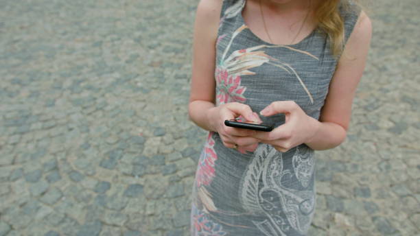 istock A Young Lady Using a Mobile Phone Outdoors 888342664