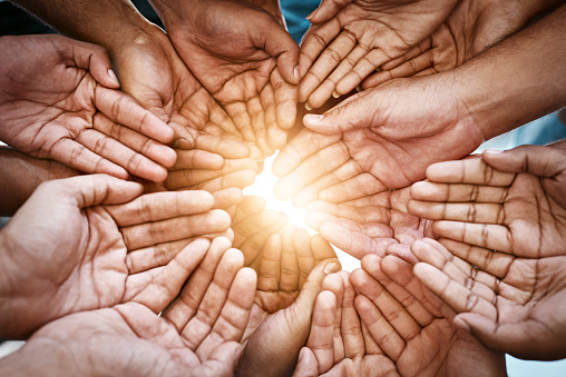 Cropped shot of a diverse group of people holding out their cupped hands