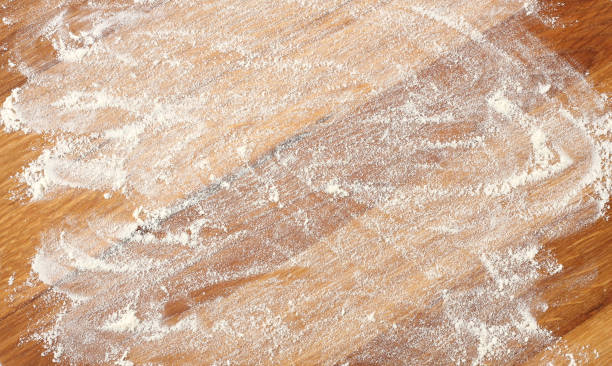 istock white flour on rustic wooden table, top view 888346222