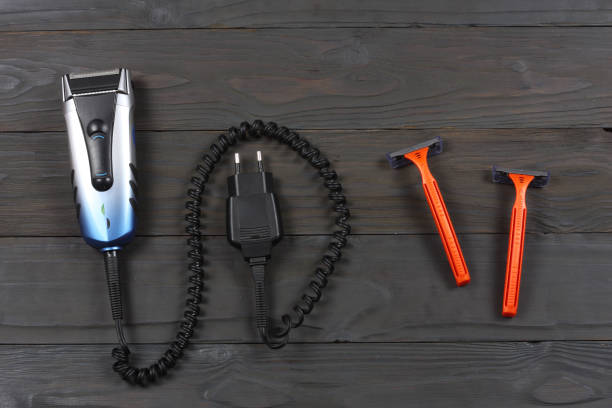 istock Electric shaver with razors on wooden table top view 888346882