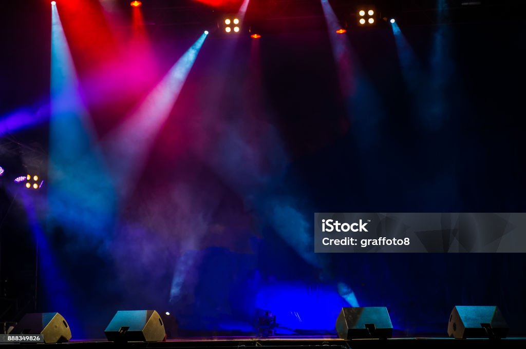 Performance moving lighting. Concert Light Show. Stage Lights. Concert stage. Beautiful Colourful disco lighting in the stage. Performance moving lighting. Concert Light Show. Stage Lights. Backgrounds Stock Photo