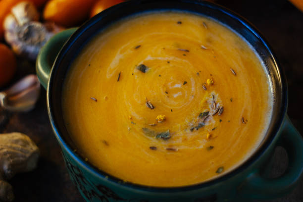 istock Delicious soup with ginger and vegetables on black surface. 888358588