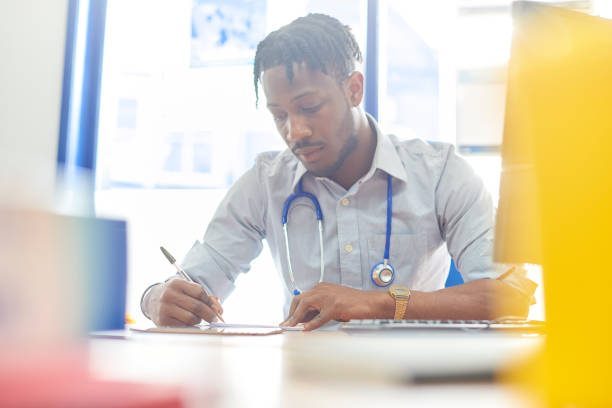 istock Writing in medical records 888368994