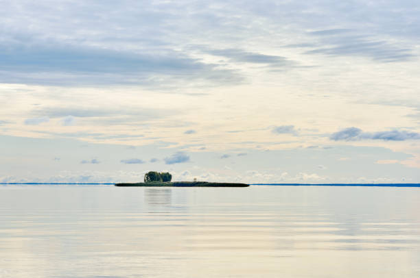 Water landscape. The lake. Beautiful landscape. Water smooth surface and the blue sky with clouds.