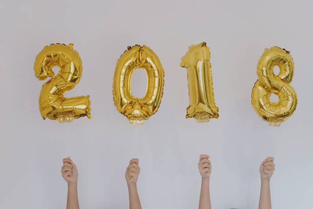 istock Hands holding golden 2018 balloons, new year concept 888394910