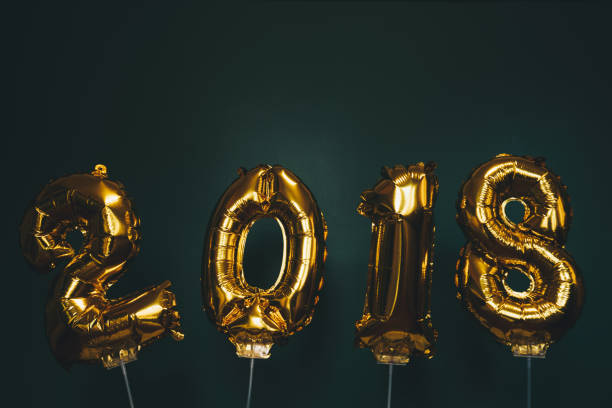istock Hands holding golden 2018 balloons, new year concept 888397952