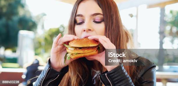 Girl Eating A Hamburger Stock Photo - Download Image Now - Teenage Girls, Eating, Burger