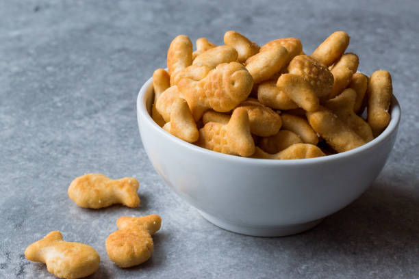 Salted Fish Crackers in a bowl. Salted Fish Crackers in a bowl. Snackers. goldfish snack stock pictures, royalty-free photos & images