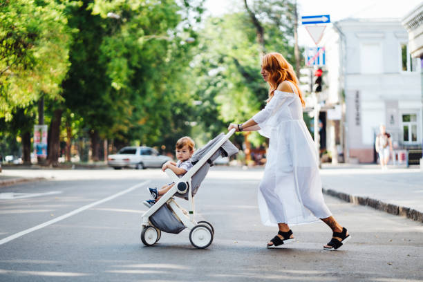 istock mom with a stroller crosses the road 888410618