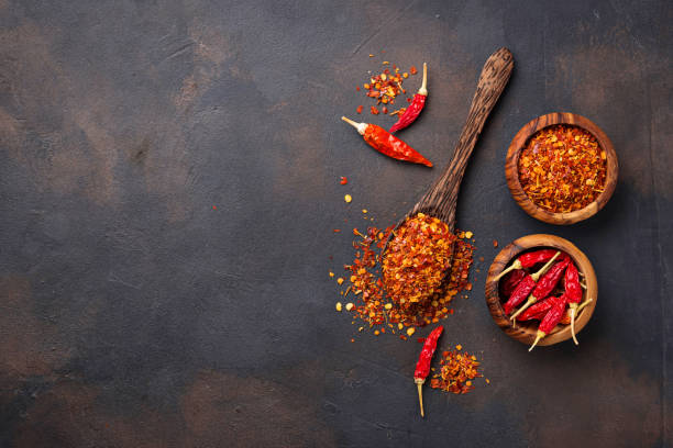 istock Red hot chili peppers on rusty background 888411434