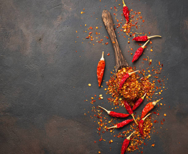 istock Red hot chili peppers on rusty background 888418184