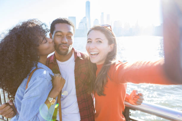 istock Three friends take selfie on sunny city pier 888418710