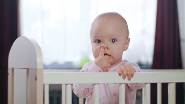 istock Baby Standing in a Crib at Home 888421066