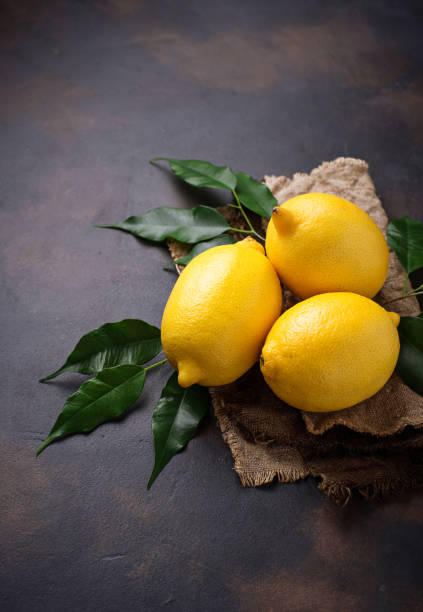 istock Fresh juicy lemons on rusty background 888421326