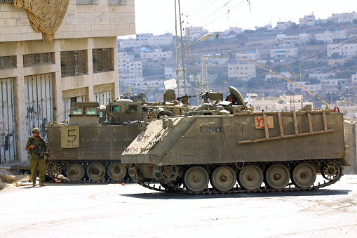 Hebron, Palestine - Oct. 5, 2001:  Israeli soldiers in armored personnel carriers guard a street in the Palestinian part of the city.  Hebron, with a large Palestinian population and a small, but fervent, Jewish contingent, has historically been a flash point in the Israeli - Palestinian conflict.