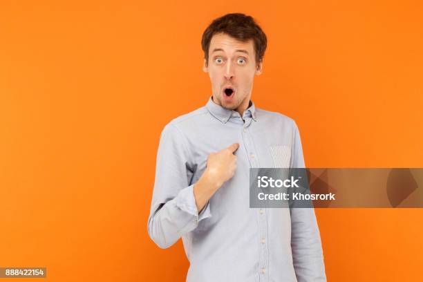 Who Im Shocked Man Looking At Camera And Pointing Finger Himself Stock Photo - Download Image Now