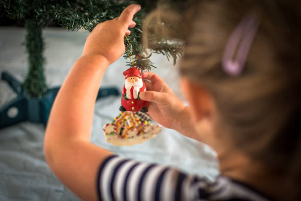 Little girl decorating christmas tree