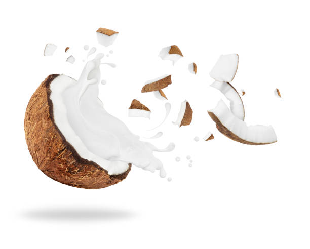 istock Broken coconut with milk splash, isolated on white background 888458690