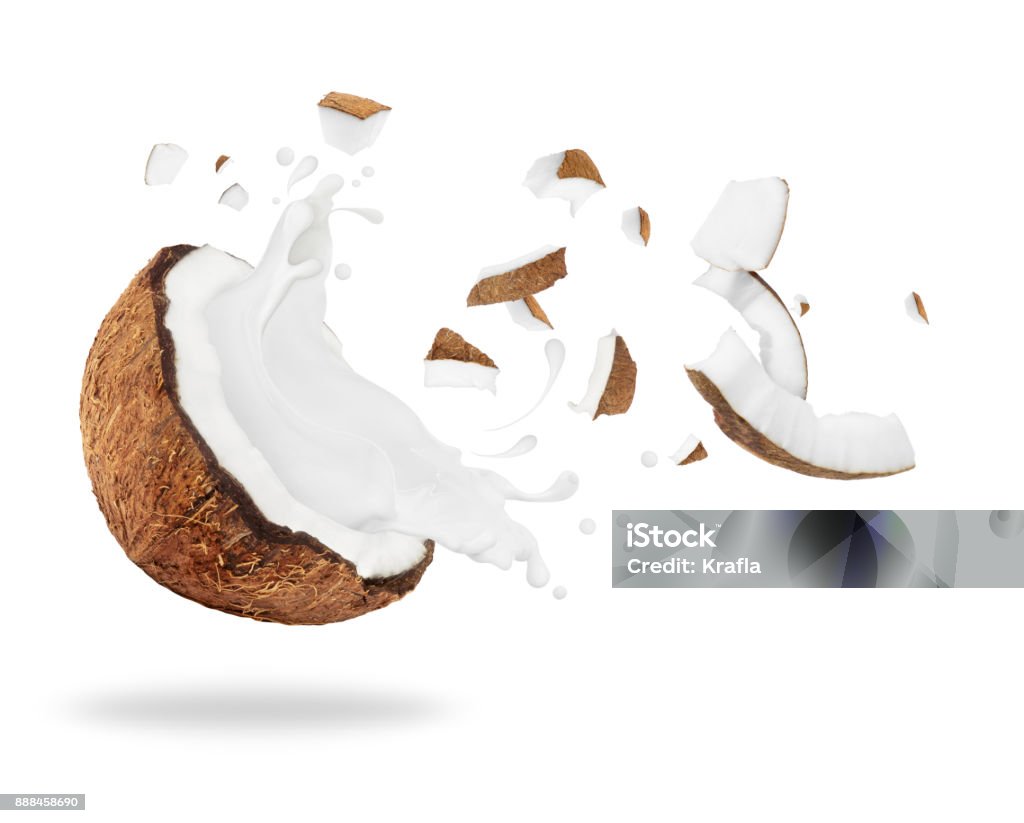 Broken coconut with milk splash, isolated on white background Coconut Stock Photo