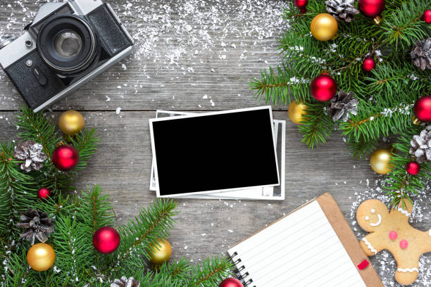 istock retro camera and christmas blank photo frame with fir tree branches, decorations and lined notebook 888470632