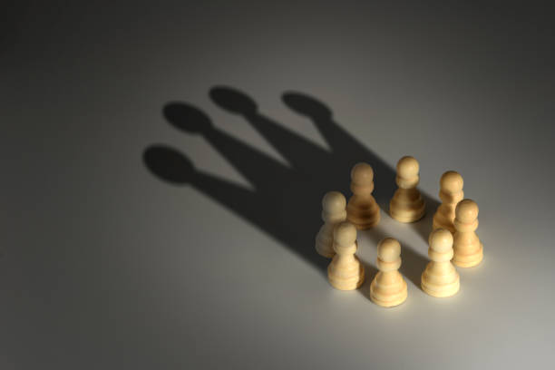 chess pawn circle with shadow shaped as a crown chess pawn circle with shadow shaped as a crown pawn chess piece photos stock pictures, royalty-free photos & images