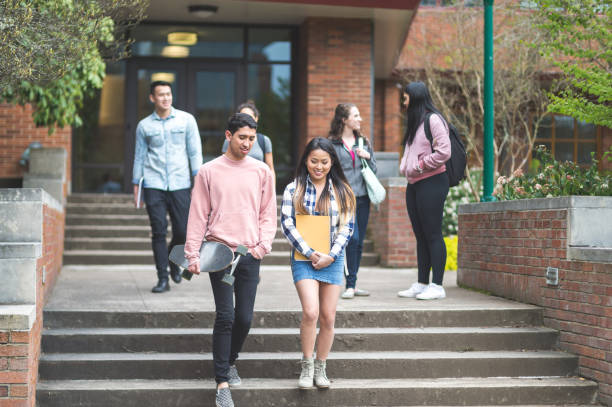 istock Two ethnic college friends leave class together and walk across campus. 888498190