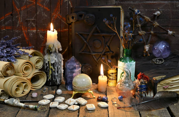 istock Black magic book with old runes, manuscripts and crystals 888500792