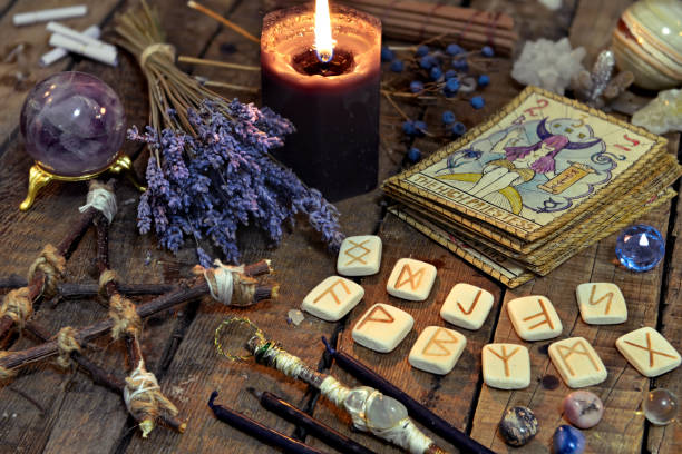 istock Tarot cards, ancient runes, black candle and pentagram 888503636