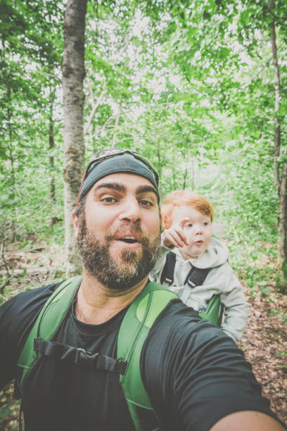 istock Father Backpacking Hiking with Toddler in Forest 888511920