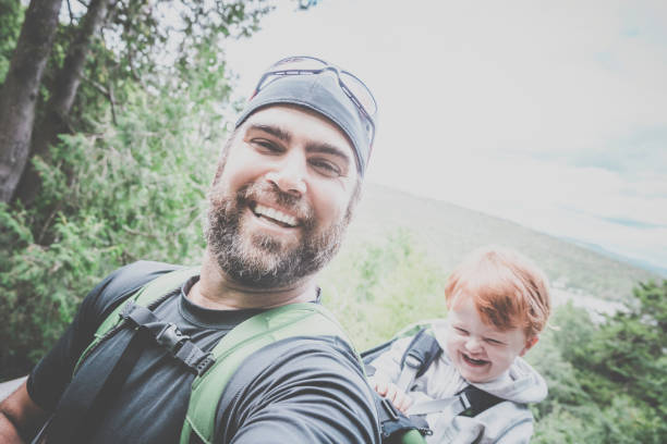 istock Father Backpacking Hiking with Toddler in Forest 888511960