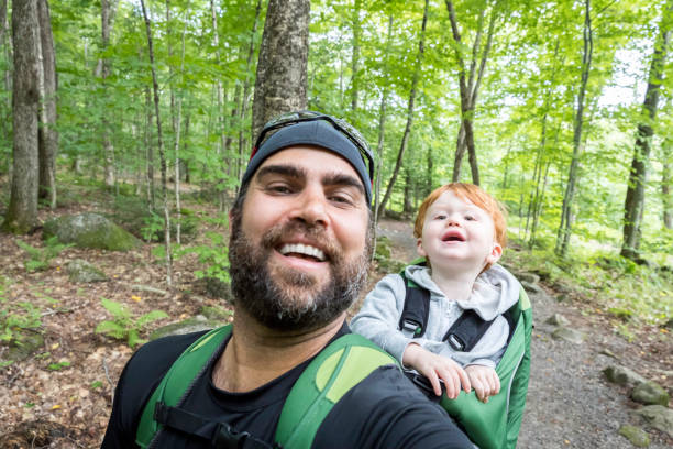 istock Father Backpacking Hiking with Toddler in Forest 888511974