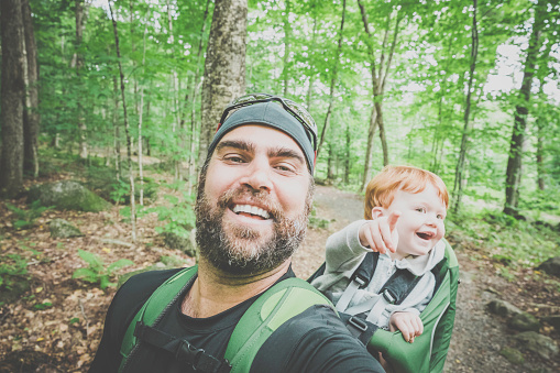 Single Father Backpacking, Hiking with baby boy Toddler inside a backpack in Forest during summer