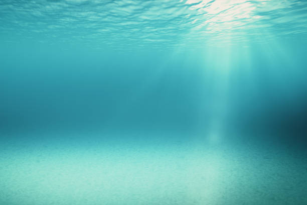 istock Blue gentle waves, slow motion looped ocean surface seen from underwater rays of sunlight shining through Great for backgrounds 3d illustration 888515120