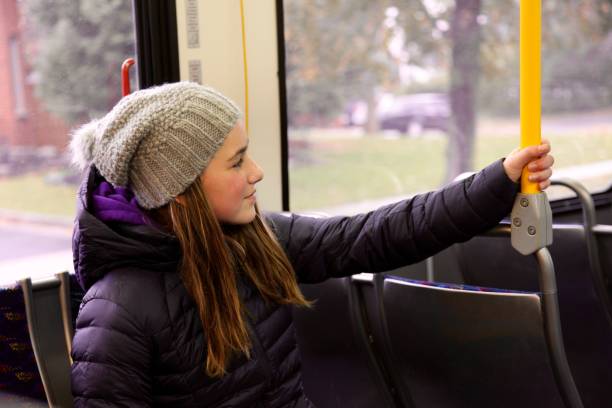 Young teenage girl riding a bus to school stock photo