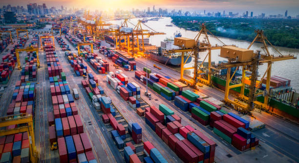 istock Logistics and transportation of Container Cargo ship and Cargo plane with working crane bridge in shipyard at sunrise, logistic import export and transport industry background 888526242