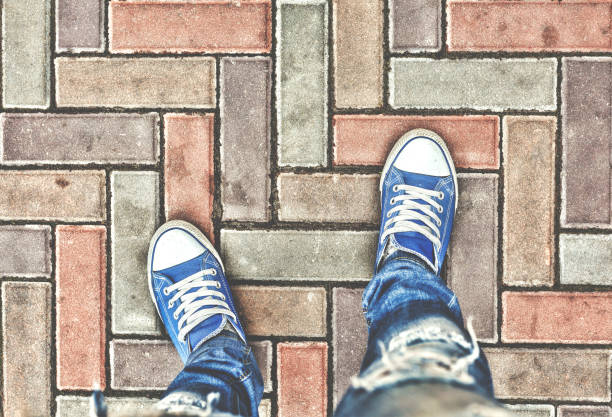 istock Legs in blue sneakers 888571650