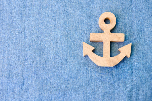 istock A white wood anchor on fabric for background 888620484