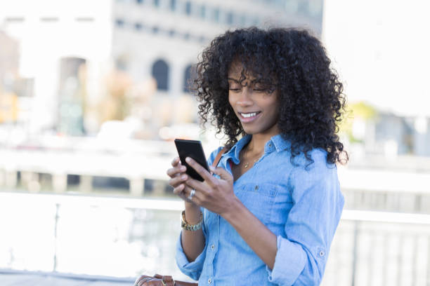 istock Beautiful woman sends text while waiting on a friend 888622850