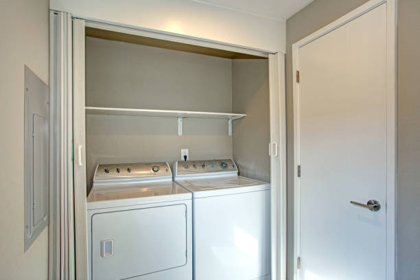istock Laundry room hidden behind white folding doors 888624938