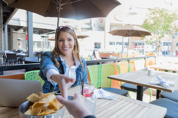 istock Professional woman greets colleague at a restaurant 888626302