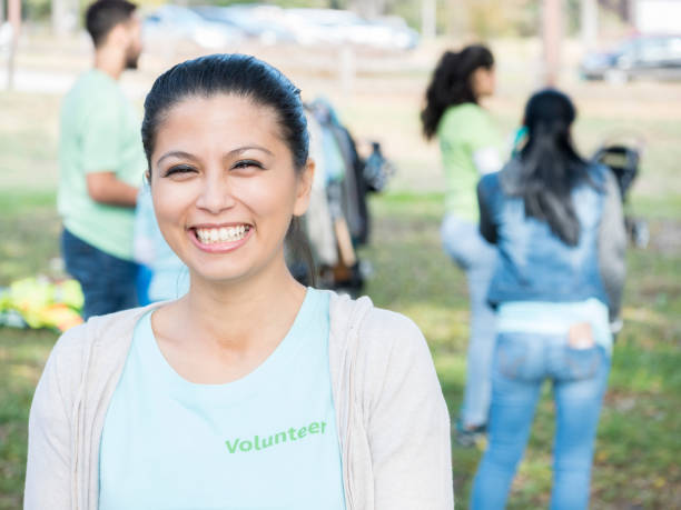 istock Confident woman helps neighbors with community cleanup 888634278