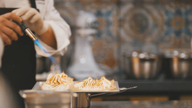 istock Cooking of meringue - chef use fire for decorates dessert 888640724