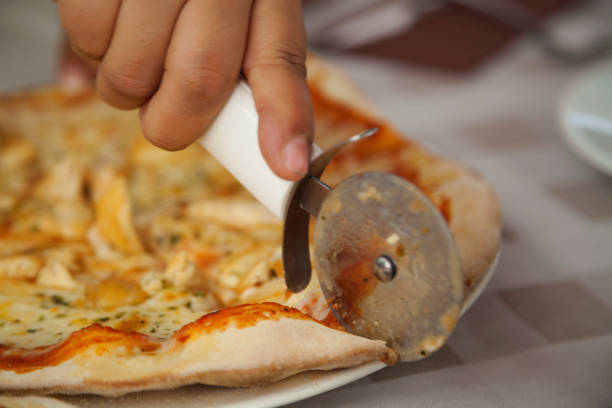 istock Woman cutting pizza 888641250