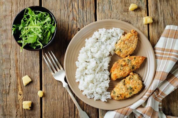 istock Baked Parmesan Parsley Crusted Chicken with rice 888647736