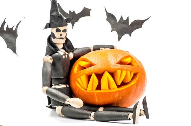 spooky halloween pumpkin with bats and wooden puppet dead man spooky halloween pumpkin with bats on white background halloween pumpkin human face candlelight stock pictures, royalty-free photos & images