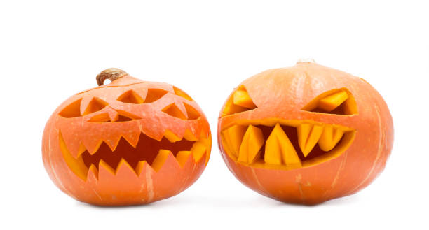 two spooky pumpkins on white background two spooky halloween pumpkins on white background halloween pumpkin human face candlelight stock pictures, royalty-free photos & images