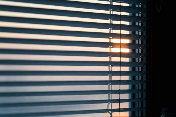 istock The sun shines through the blinds. 888653096