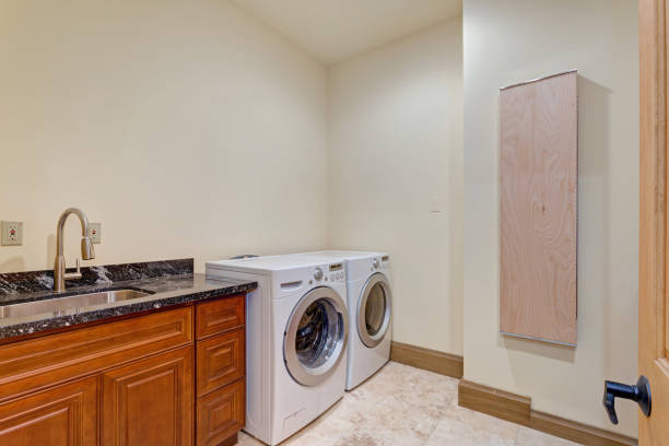 istock Newly outfitted laundry room with a sink 888660960
