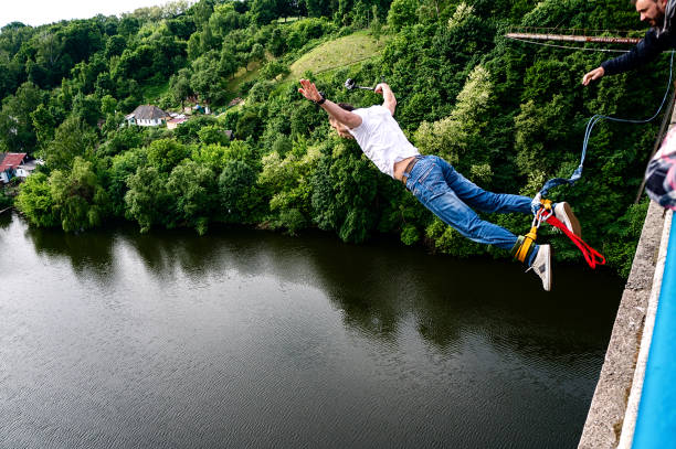 Zhytomyr, Ukraine - May 30, 2015: Extreme jump from a 42 m high pedestrian bridge. Leap with a rope.