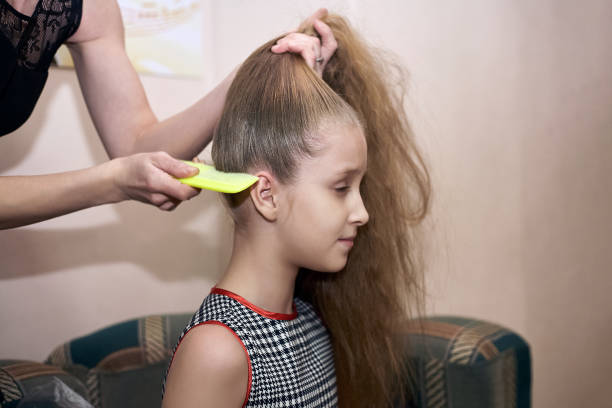 istock Mom makes daughter hairstyle preparing her for the performance. 888662312